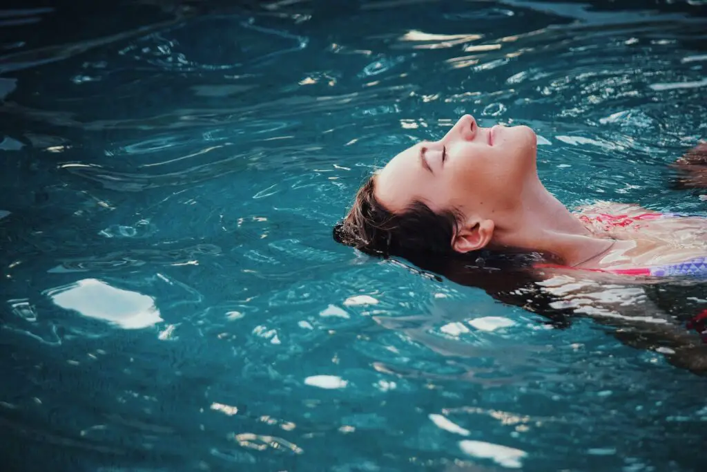 clarifier in pool woman floating on body of water